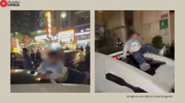 Greater Noida man driving sports car with child on roof