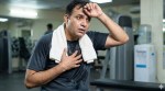 An Indian man after a workout is worried after his heart that suddenly starts racing, with his hand on his heart