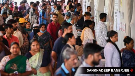 Citizens check for their names in the voter list before casting their votes for BMC election, at Dharavi Transit Camp Municipal school, in Mumbai on 15 January.