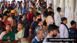 Citizens check for their names in the voter list before casting their votes for BMC election, at Dharavi Transit Camp Municipal school, in Mumbai on 15 January.