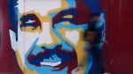 A pedestrian walks past a mural of Venezuelan President Nicolas Maduro Sunday, Jan. 4, 2026. AP/PTI(AP01_04_2026_000315A)