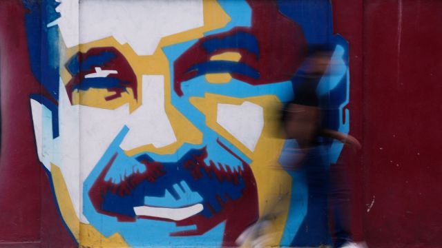 A pedestrian walks past a mural of Venezuelan President Nicolas Maduro Sunday, Jan. 4, 2026. AP/PTI(AP01_04_2026_000315A)