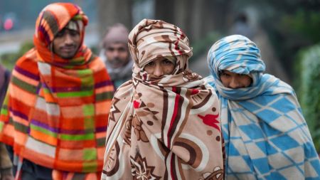 People wrapped in blankets amid dense fog on a cold winter morning, in New Delhi, Thursday, Jan. 1, 2026. (PTI)