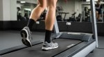 A person walking on a treadmill at a gym