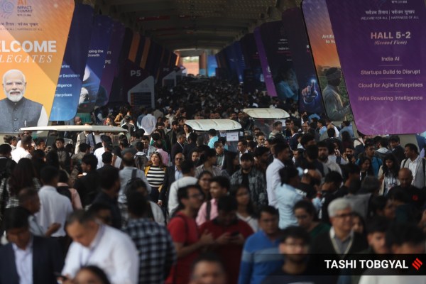 A large crowd gathers to attend the first India AI Impact Summit in New Delhi. (Express Photo/Tashi Tobgyal)