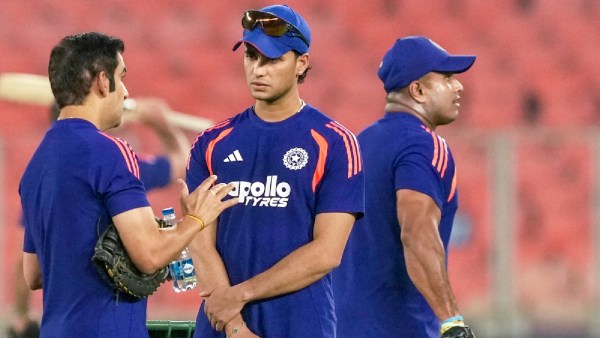 India's Abhishek Sharma, centre, and head coach Gautam Gambhir, left, interact during a practice session before an ICC Men's T20 World Cup 2026 cricket match between India and South Africa, at the Narendra Modi Stadium, in Ahmedabad, Friday, Feb. 20, 2026. (PTI Photo)