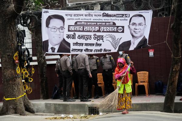 A municipal worker cleans a road near the chairman office of the Bangladesh Nationalist Party (BNP) a day after the national parliamentary election in Dhaka. (AP Photo)