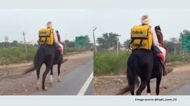 Dressed in traditional attire and a turban, the man rides with a bright yellow Blinkit delivery bag