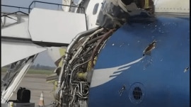 Debris and engine cowling damage visible on the Arik Air Boeing 737-700 after the emergency landing in Benin. (Image Source: NSIB)