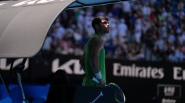 Carlos Alcaraz waits as a medical emergency in the stands of Rod Laver Arena holds up play during Australian Open. (PHOTO: AP)