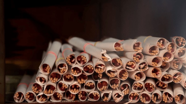 Incense sticks wrapped in paper money offerings, which are burned by devotees during the ritual as a symbolic offering seeking guidance, prosperity and blessings.