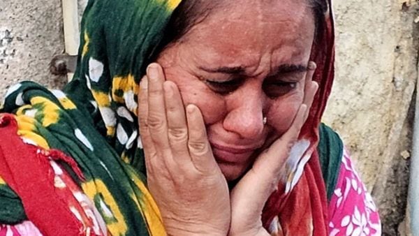 A woman stand amid debris after demolition drive, many say they were informed only three days ago and remain unsure about where to relocate. (Photo: Chirag Chotaliya)