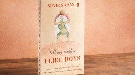 A 3D book cover of Tell My Mother I Like Boys by Suvir Saran standing on a wooden table.