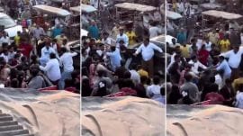 The purported video shows a group of over 20 men — some armed with sticks — on a crowded road surrounding the jawan, raining repeated punches and kicks, even as he attempts to hit them back.
