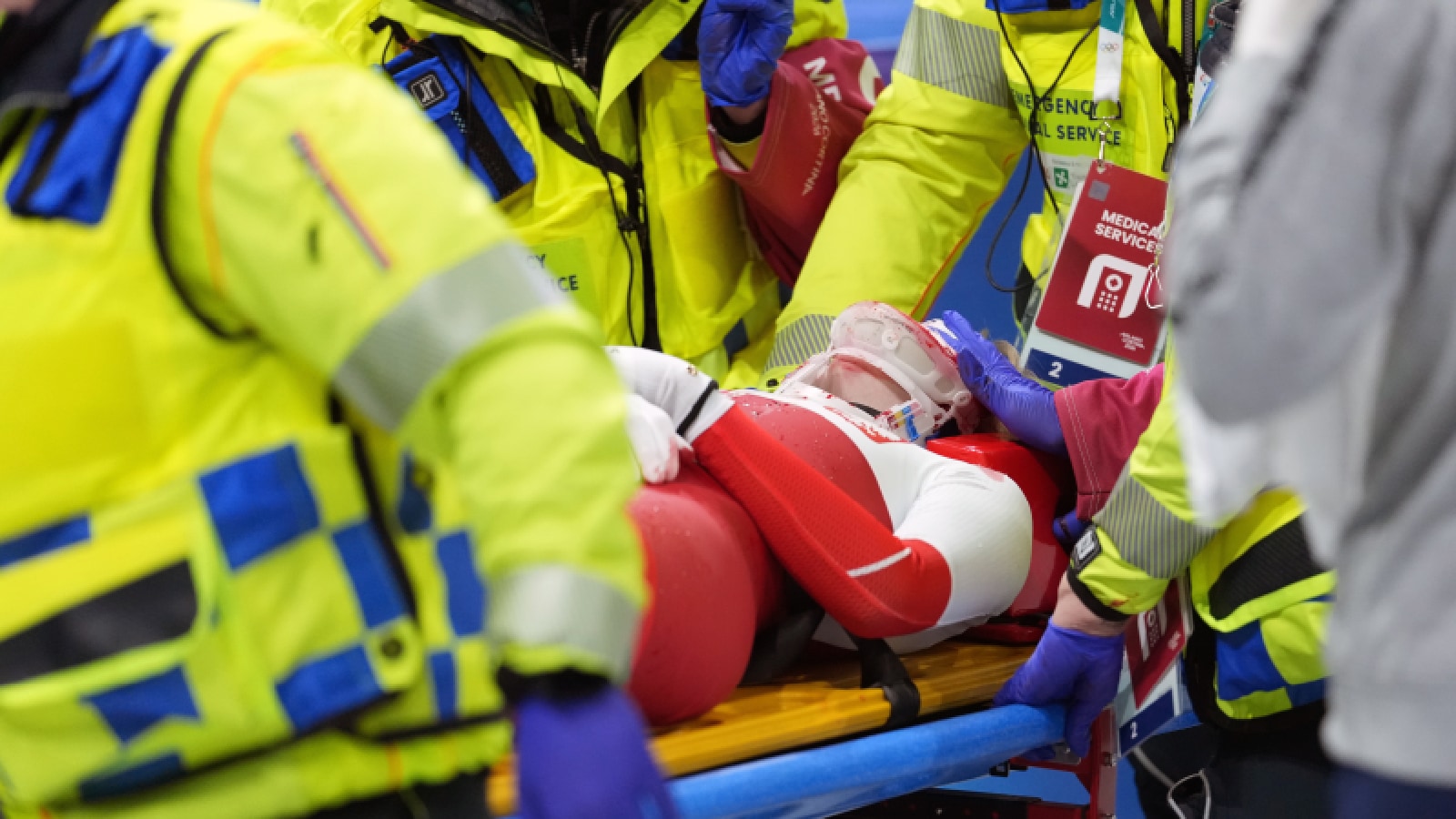 Kamila Sellier (in white jersey) is stretched off the ice after getting injured in a crash and being struck in the face with a skate blade while competing during a short track speed skating women's 1,500 meters at the 2026 Winter Olympics. (Darryl Dyck/The Canadian Press via AP)
