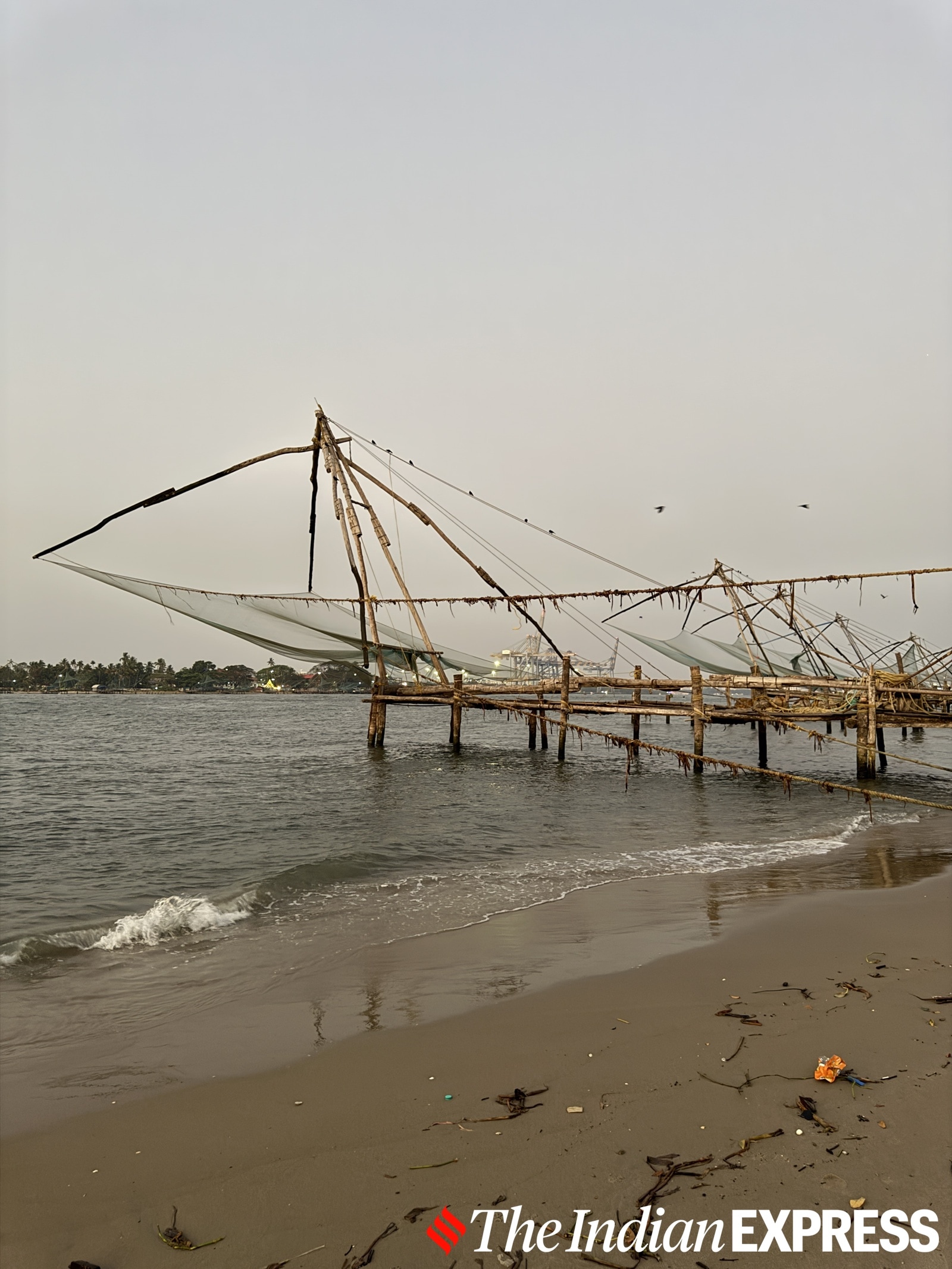 Chinese fishing nets stand still against the rhythm of the tides