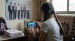 Young girl watching Korean idols dancing on phone screen depicting parasocial bonds
