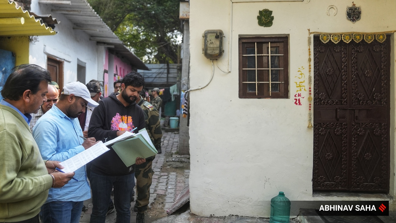 L&DO staffs paste notice and allotment paper at DID camp near Race Course at New Delhi