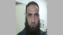 Police say he recruited and directed operatives while evading arrest and fleeing to Bangladesh.