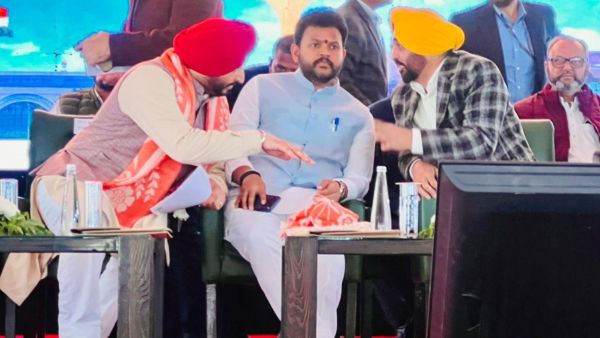 Mann in discussion with both union ministers at Halwara, Sunday. (Express photo)