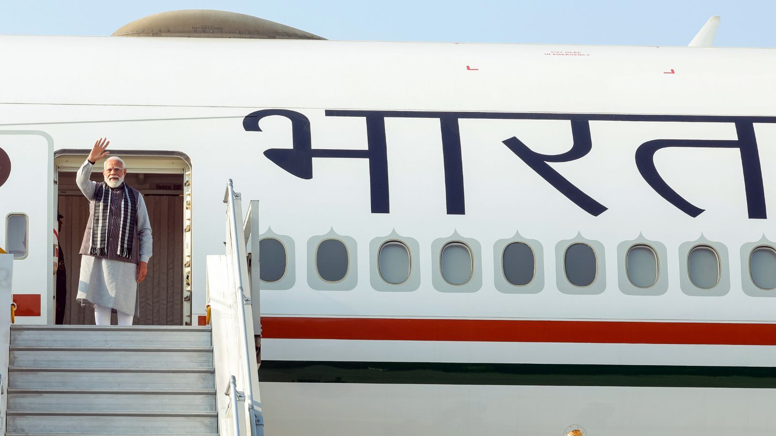 Prime Minister Narendra Modi waves as he emplanes for a two-day visit to Israel, in New Delhi on Wednesday.