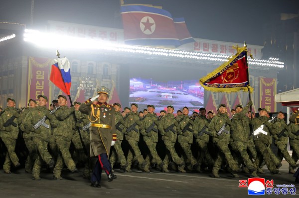 In this photo provided by the North Korean government, a soldier who was dispatched to Russia carries a Russian flag during a parade at Kim Il Sung Square in Pyongyang, North Korea. (AP Photo)