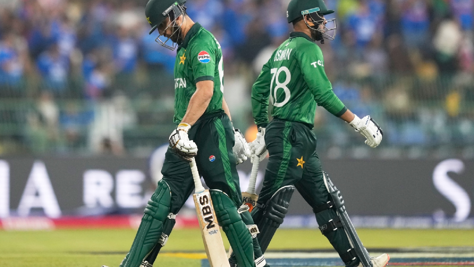 Pakistan's captain Salman Ali Agha, left, leaves the ground after losing his wicket as teammate Usman Khan walks in during the T20 World Cup cricket match between India and Pakistan in Colombo, Sri Lanka. (AP Photo)