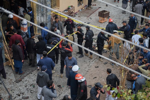 Pakistani security officials examine the site of of a bomb explosion at a Shiite mosque, in Islamabad, Pakistan. (AP Photo)