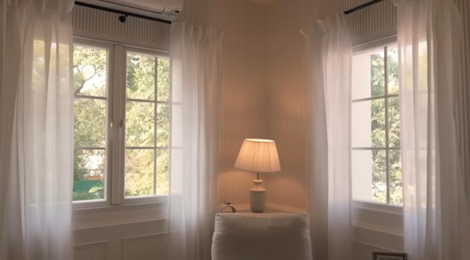 Transparent curtains allow views of trees and nature, while soft plush fabrics ensure comfort throughout the room