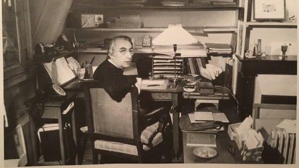 Black-and-white portrait of Roland Barthes seated and looking toward the camera.