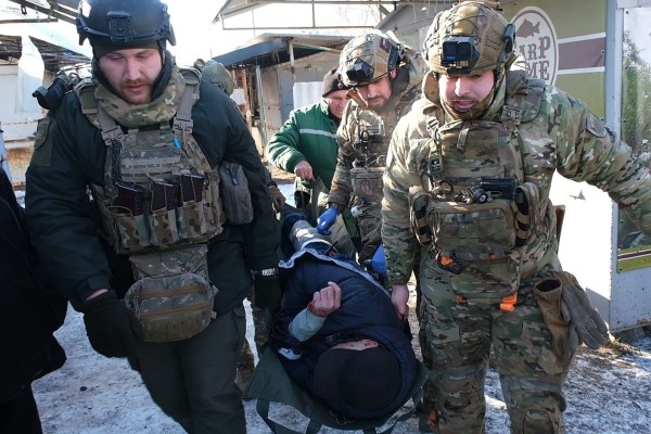 Military paramedics evacuate a wounded civilian after the Russian shelling in the town of Druzhkivka, Donetsk region. (Ukrainian Police Press Service via AP)