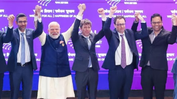 Sam Altman and Dario Amodei raising hands with Modi