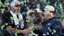 Seattle Seahawks head coach Mike MacDonald and quarterback Sam Darnold, left, hold the Lombardi Trophy after a win over the New England Patriots in the NFL Super Bowl 60 football game. (AP Photo)