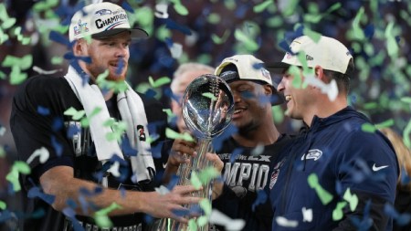 Seattle Seahawks head coach Mike MacDonald and quarterback Sam Darnold, left, hold the Lombardi Trophy after a win over the New England Patriots in the NFL Super Bowl 60 football game. (AP Photo)
