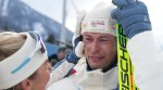 Sturla Holm Laegreid, of Norway, reacts after he won bronze as teammate Ingrid Landmark Tandrevold comforts him after the men's 20-kilometer individual biathlon race at the 2026 Winter Olympics in Anterselva, Italy, Tuesday, Feb. 10, 2026. (AP Photo)