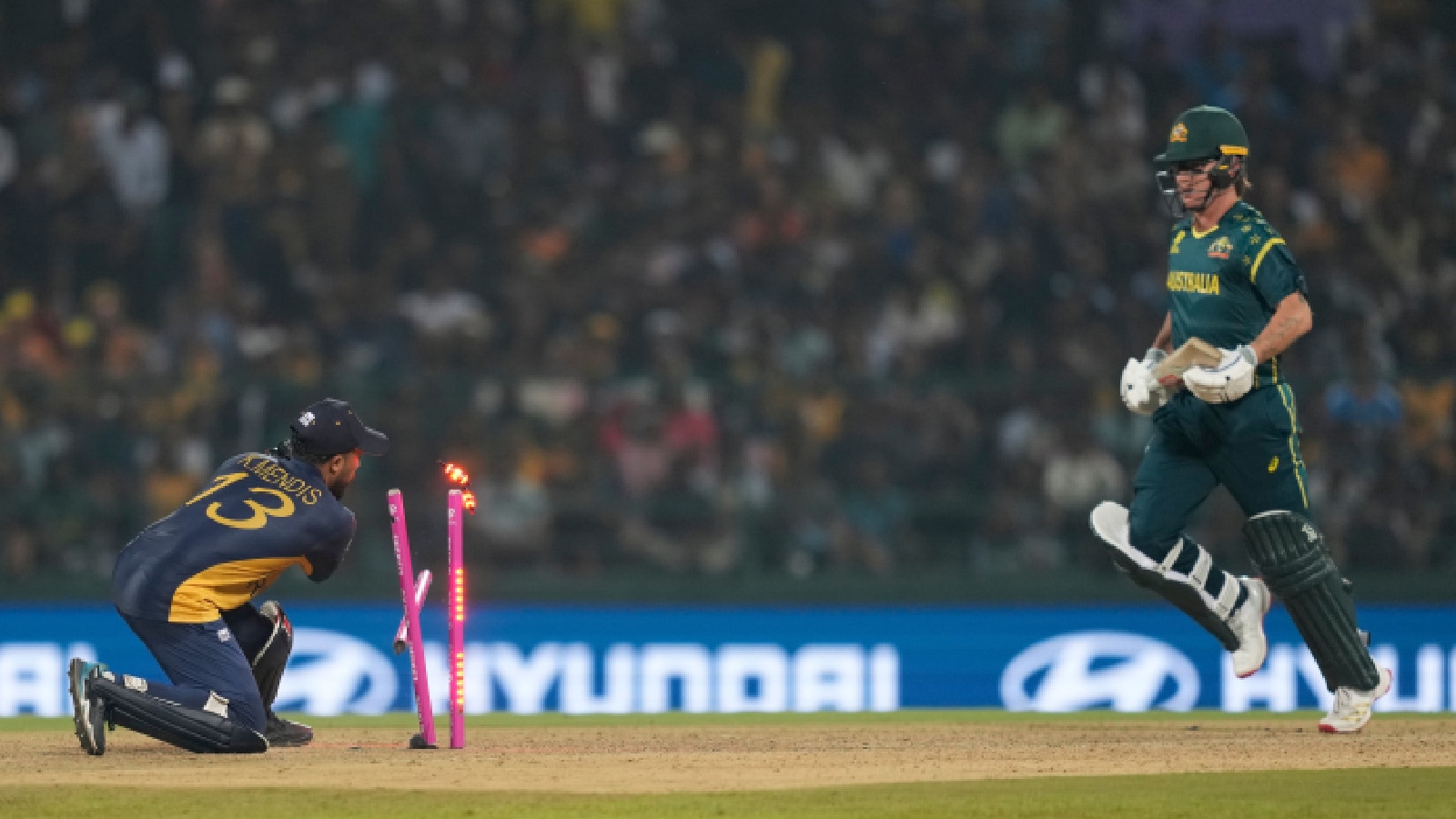 Sri Lanka's Kusal Mendis, left, shatters the stumps to get Australia's Adam Zampa run out during the T20 World Cup cricket match between Sri Lanka and Australia in Pallekele, Sri Lanka. (AP Photo)