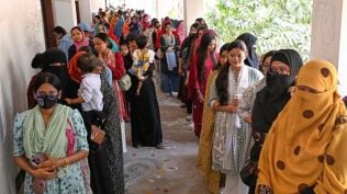 Women queue up to cast their vote at a polling station on Thursday (AP Photo)