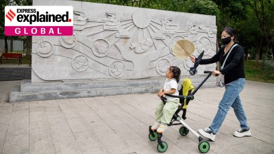 A woman and a child pass at a park in Beijing, China, Sept. 18, 2024.