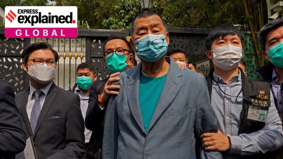 Hong Kong media tycoon Jimmy Lai, center, who founded local newspaper Apple Daily, was arrested by police officers at his home in Hong Kong on April 18, 2020. (AP Photo)