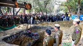 The DJB claimed in an official statement that preliminary investigations showed that the road on which work was underway had been closed with barricades and green mesh, and that the pit too, had been protected with green mesh. (Express photo by Praveen Khanna)