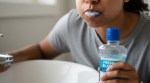 Woman rinsing her mouth with a mouthwash