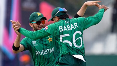 Pakistan's Babar Azam, right, and teammate Shaheen Shah Afridi celebrate after taking a co-ordinated catch to dismiss Netherlands' Michael Levitt during the T20 World Cup cricket match between Netherlands and Pakistan in Colombo, Sri Lanka, Saturday, Feb. 7, 2026. (AP Photo/Eranga Jayawardena)