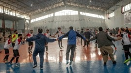 The Omid Sadat team celebrates their victory at the final of a local league futsal tournament in Kabul, Afghanistan, Dec. 12, 2025. (Tomás Munita/The New York Times)