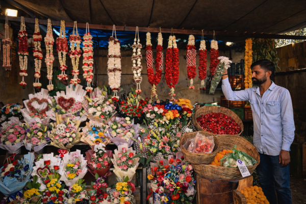 Customers browse bouquets and garlands at a flower stall in Jamalpur market ahead of Valentine’s Day in Ahmedabad on Thursday. (Express Photo)
