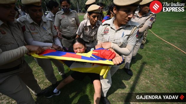 Members of the Tibetan community and supporters raise slogans against the Chinese Communist Party