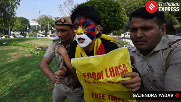 Demonstrators hold placards and chant slogans during the protest organised by the Tibetan Youth Congress