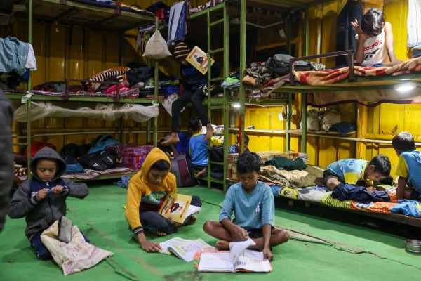 Students study inside the academy’s residential quarters after a day of training and school in Narayanpur.