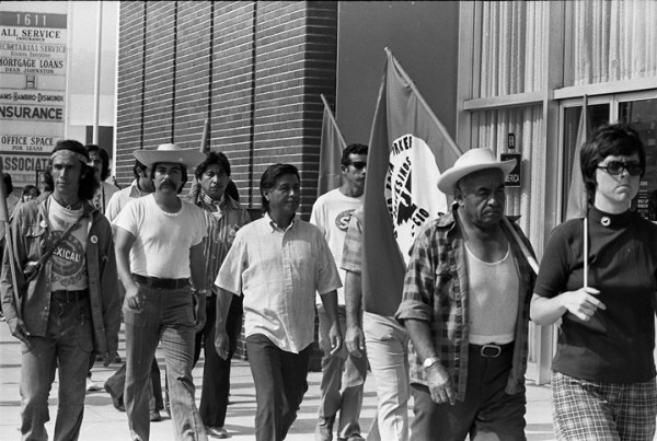 Cesar Chavez (center) on a march from the Mexican border to Sacramento with United Farm Workers members in Redondo Beach, California, July 1975. (Wikimedia Commons)