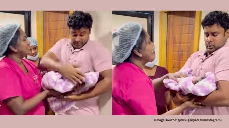 After being reassured by the doctor, the father carefully held the child