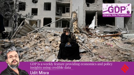 A woman sits on rubble across from a residential building damaged last Sunday during the US-Israeli air attacks on Tehran, Iran.